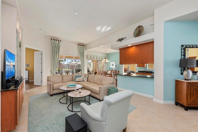 living room with light tile patterned floors, baseboards, and a chandelier