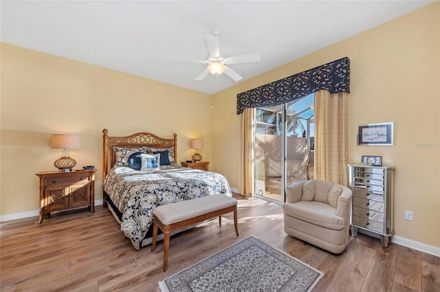 bedroom featuring access to exterior, ceiling fan, baseboards, and wood finished floors