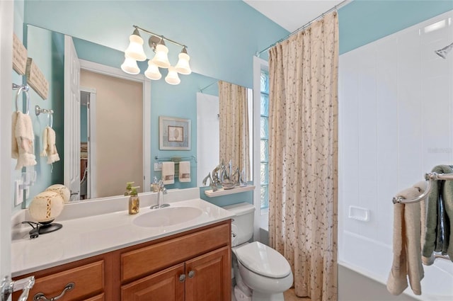 full bath featuring a chandelier, shower / bath combo, vanity, and toilet