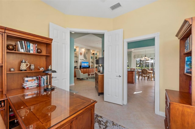 office area featuring light tile patterned floors, baseboards, visible vents, and an inviting chandelier