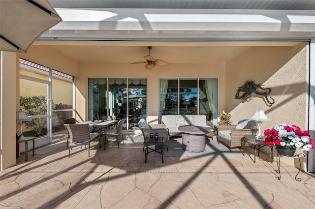 view of patio / terrace with outdoor dining space, ceiling fan, and an outdoor living space