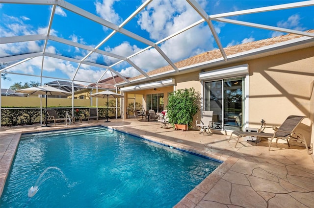 outdoor pool with glass enclosure and a patio area