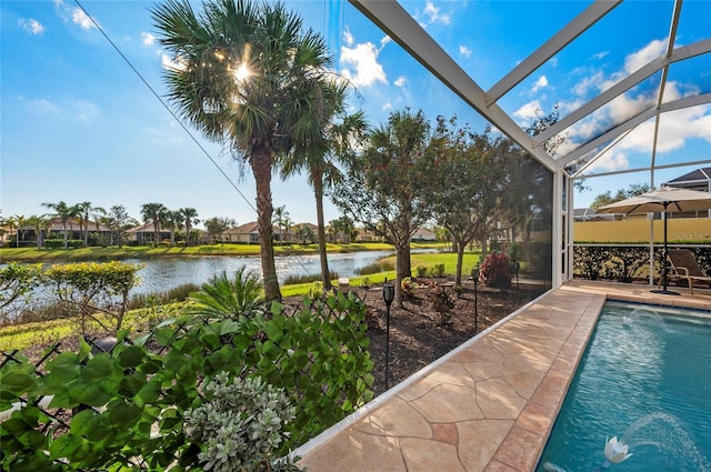 pool with a lanai and a water view