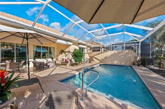 pool featuring a patio area, glass enclosure, and an outdoor living space