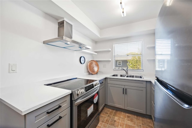 236 Harbor Dr S Unit 202, Venice, FL 34285 - kitchen featuring appliances with stainless steel finishes, wall chimney range hood, gray cabinetry, open shelves, and light countertops