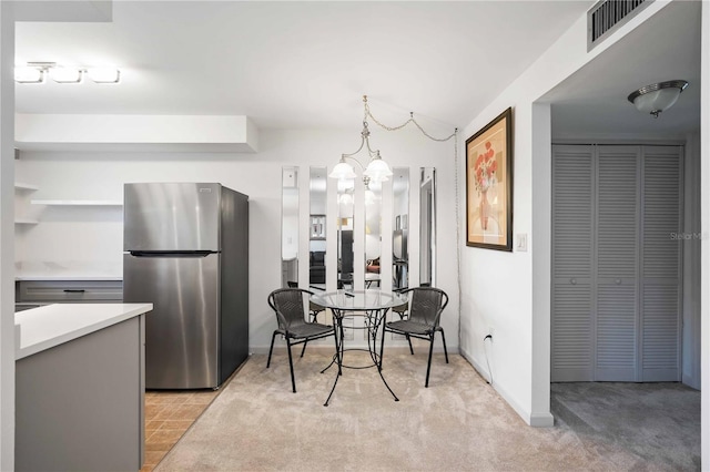 236 Harbor Dr S Unit 202, Venice, FL 34285 - dining area featuring a chandelier and light carpet