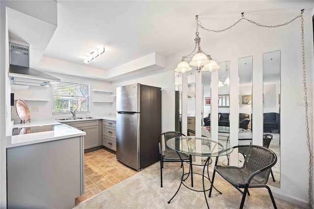 236 Harbor Dr S Unit 202, Venice, FL 34285 - kitchen featuring freestanding refrigerator, gray cabinetry, open shelves, extractor fan, and stovetop
