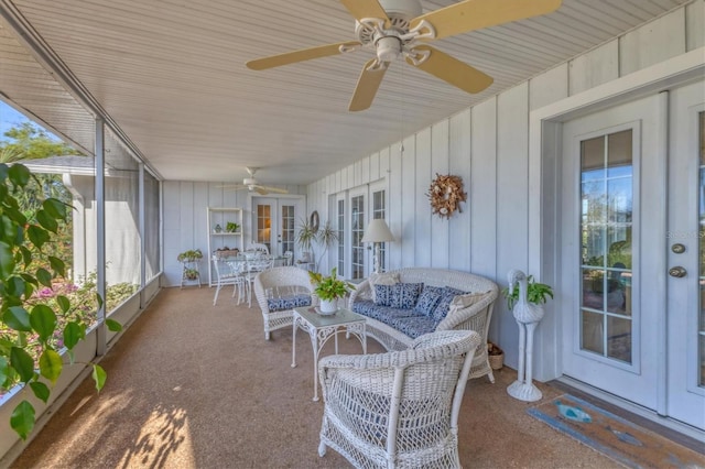 sunroom with a ceiling fan and french doors