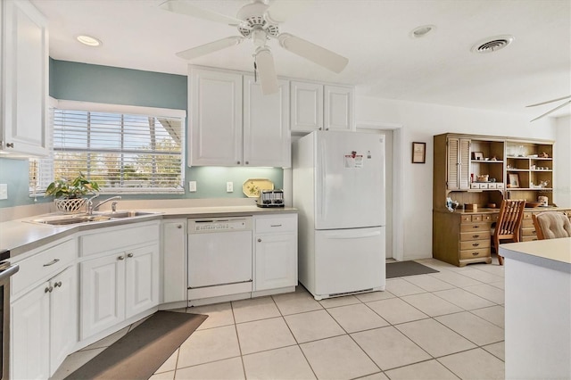 kitchen featuring a sink, white appliances, a ceiling fan, white cabinetry, and visible vents