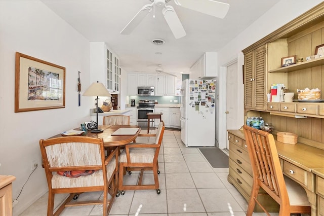 dining space featuring light tile patterned floors, a ceiling fan, and visible vents