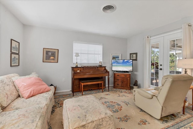 living room with baseboards, visible vents, and french doors