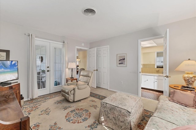 living room featuring baseboards, french doors, and visible vents