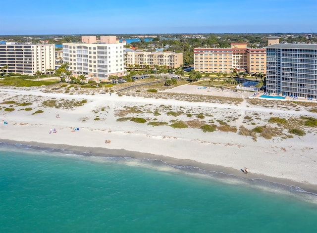 birds eye view of property with a view of city, a water view, and a beach view