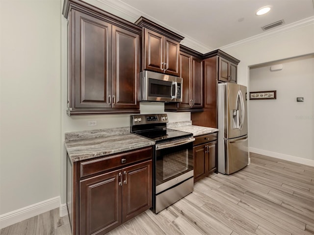 kitchen featuring light wood-style flooring, appliances with stainless steel finishes, ornamental molding, dark brown cabinets, and baseboards