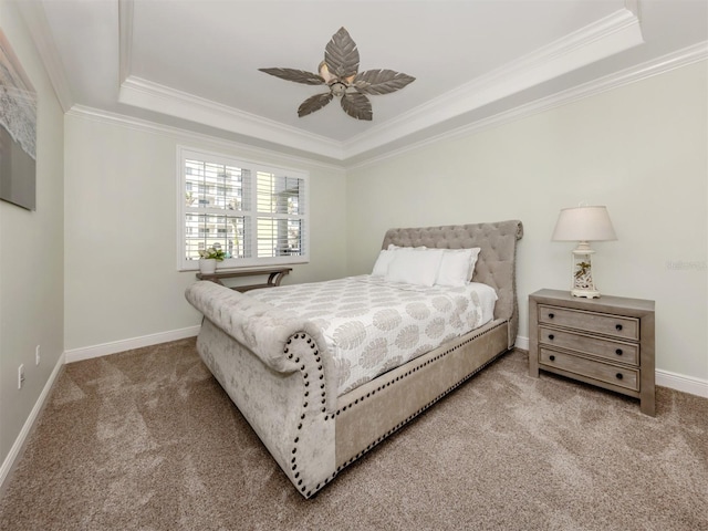 bedroom featuring a raised ceiling, carpet flooring, crown molding, and baseboards