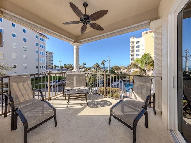 exterior space with a balcony and a ceiling fan