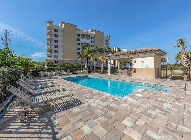 pool featuring a patio area and fence