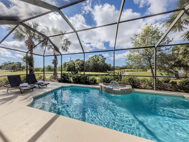 view of pool featuring a patio area, a pool with connected hot tub, and glass enclosure