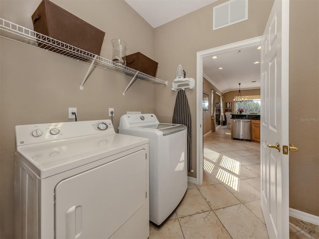 laundry room featuring visible vents, light tile patterned flooring, separate washer and dryer, laundry area, and baseboards