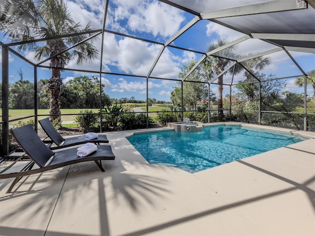 view of swimming pool featuring glass enclosure, a patio area, and a pool with connected hot tub