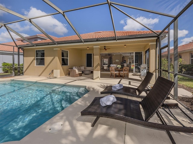 back of house with a patio area, a tile roof, outdoor lounge area, and stucco siding