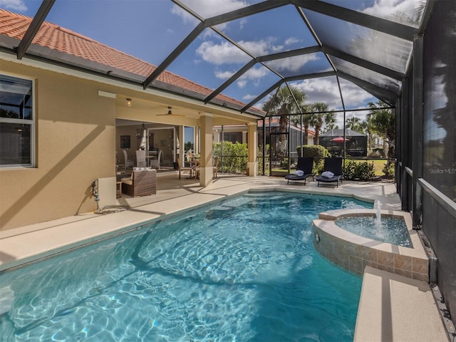 view of pool featuring a patio, a pool with connected hot tub, a lanai, and a ceiling fan