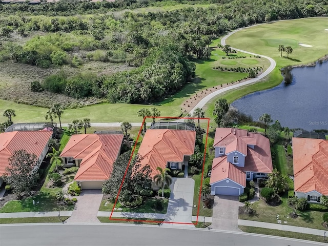 aerial view with golf course view and a water view