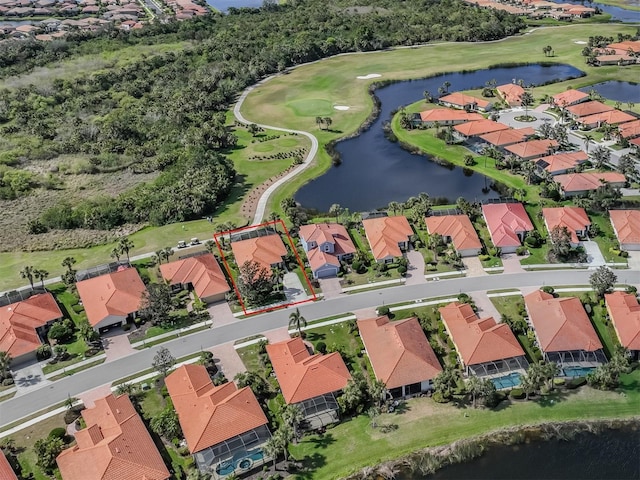 bird's eye view with view of golf course, a water view, and a residential view