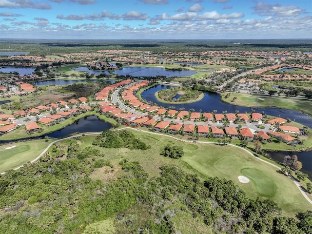 birds eye view of property featuring golf course view, a water view, and a residential view