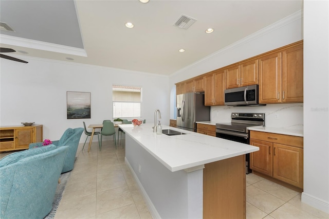 kitchen featuring appliances with stainless steel finishes, open floor plan, visible vents, and a sink