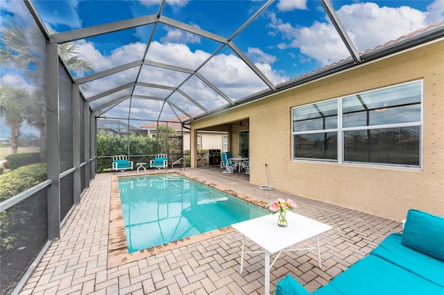 pool with a patio and glass enclosure