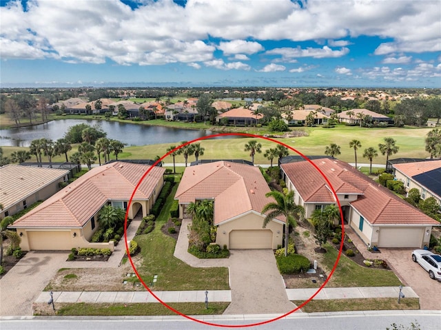 birds eye view of property with a water view and a residential view