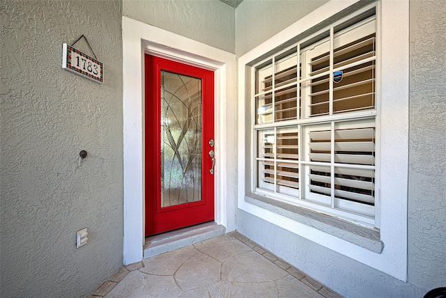 property entrance with stucco siding