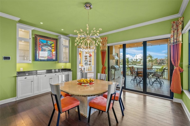 dining room with a notable chandelier, baseboards, dark wood-style flooring, and ornamental molding