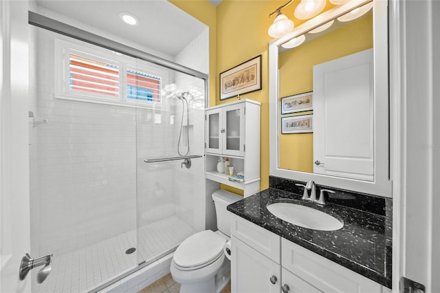 full bathroom featuring a stall shower, vanity, toilet, and recessed lighting