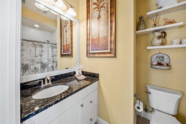 bathroom featuring visible vents, a shower with shower curtain, vanity, and toilet