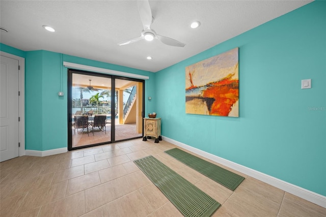 tiled empty room featuring recessed lighting, ceiling fan, a textured ceiling, and baseboards