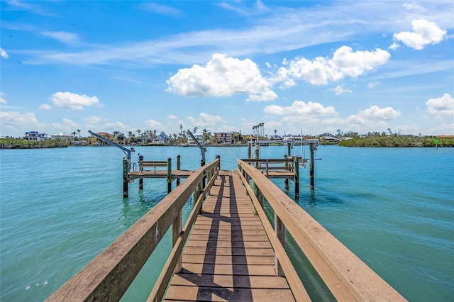 dock area with a water view and boat lift