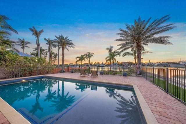 view of swimming pool featuring a fenced in pool, a patio area, and fence