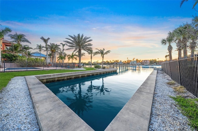 view of pool featuring a dock and fence