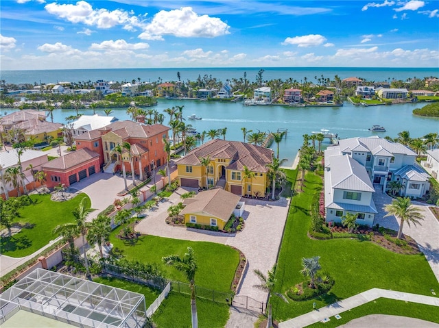 drone / aerial view featuring a water view and a residential view