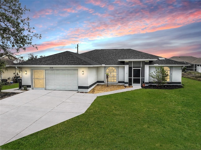 view of front of house featuring a garage, concrete driveway, roof with shingles, stucco siding, and a front lawn