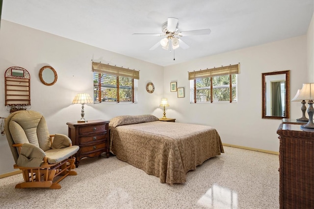 bedroom with multiple windows, baseboards, and ceiling fan