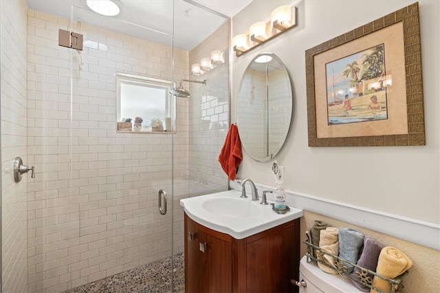 full bathroom with vanity, toilet, and a stall shower