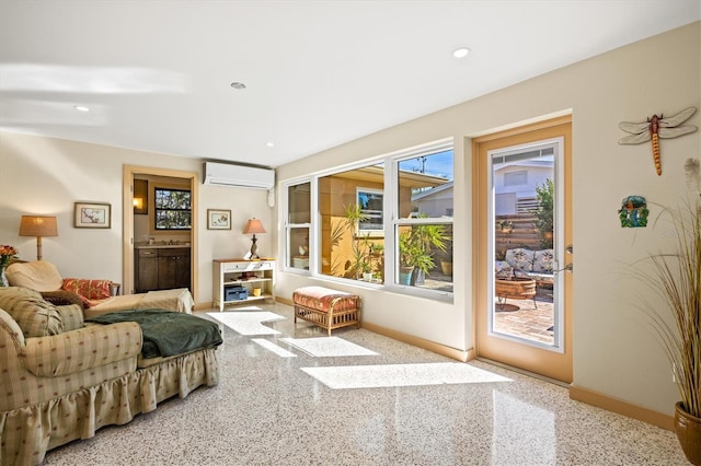 bedroom with recessed lighting, multiple windows, access to outside, and a wall unit AC