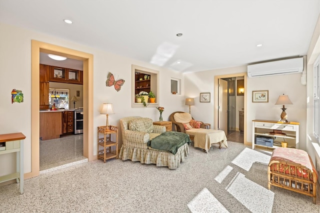 living area featuring recessed lighting, speckled floor, and a wall unit AC