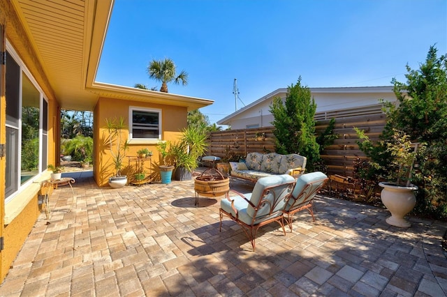 view of patio / terrace featuring fence and an outdoor fire pit