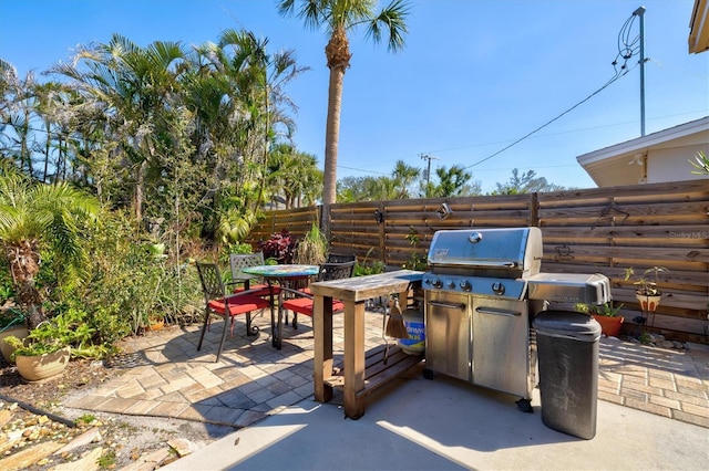 view of patio / terrace with outdoor dining space, area for grilling, and fence