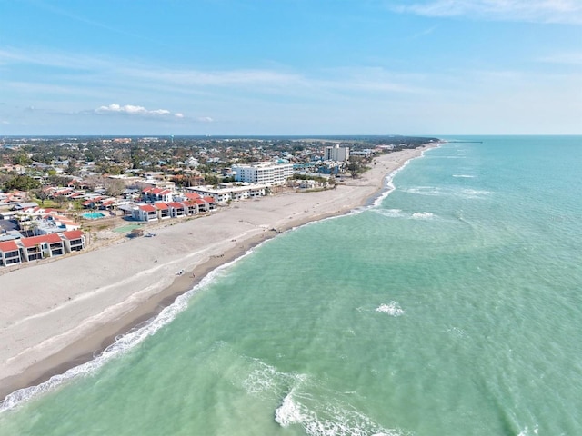 drone / aerial view featuring a view of city, a beach view, and a water view