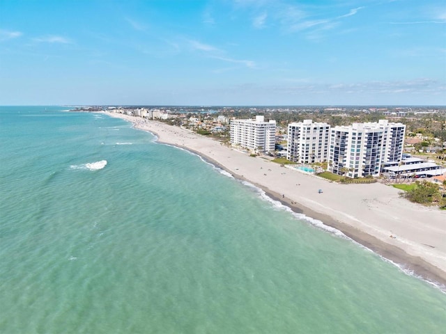 drone / aerial view featuring a city view, a beach view, and a water view